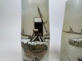 two vases that have been painted with windmills on them