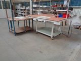 a workbench in the middle of a room with a lot of work on it