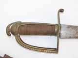 a close up of a knife and a knife rest on a wall