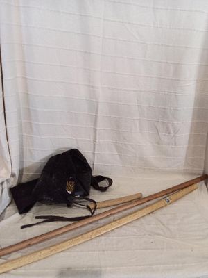 a black bag and a pair of wooden skis on a white sheet