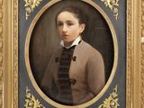 portrait of a young man in a brown jacket and black bow tie