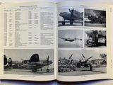 many pictures of airplanes in this book on the table