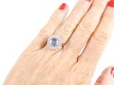 woman ' s hand with red manicured nails and a diamond ring