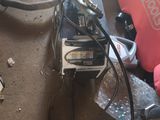 une petite machine posée par terre à côté d'un sac rouge