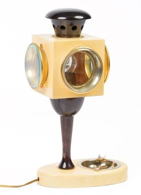 a lamp that is on a stand with a light on top of it