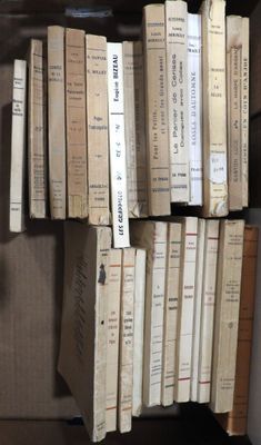 a lot of books that are stacked up on a shelf