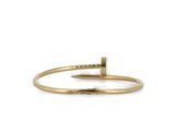 a gold bracelet with a bar on it