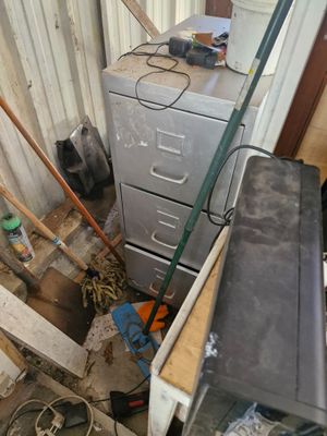 a metal filing cabinet in the corner of a room
