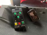 a remote control sitting on top of a black bag