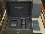a box with a watch and other items on a table