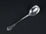 a spoon that is sitting on a black surface