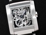 a close up of a watch on a black surface