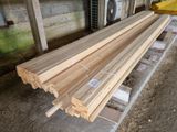 several pieces of wood are stacked on a pallet in front of a building