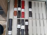 a person that is holding a case with many watches in it