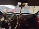 a steering wheel and dashboard of a car in a parking lot