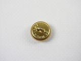 a close up of a gold button on a white surface