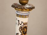a vase that has a candle on top of it