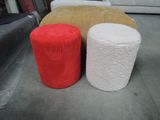 three different colored stools sitting next to each other on the floor
