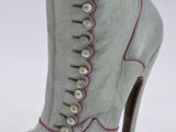 pair of grey boots with pink trims and buttons on them