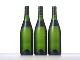three bottles of wine that are sitting on a table