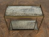 brass and glass side table with two shelves on a herringle tile floor