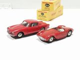 two toy cars sitting next to each other on a table
