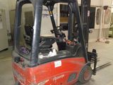 a red fork truck parked inside of a building