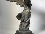 statue of a woman holding a bird on a marble base
