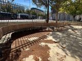 a wooden bench in the middle of a park