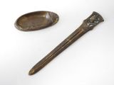 pair of antique spoons and spoon rest on a white surface