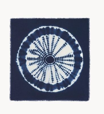 tie - dyed blue and white rug with a circular design in the middle