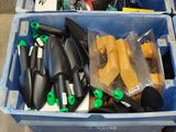 a blue bin filled with gardening tools and a pair of scissors
