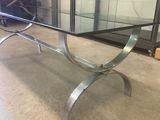 a glass table with a metal base and a glass top