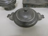 a silver teapot sitting on a table next to other items