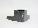 a black cup that is sitting on top of a table
