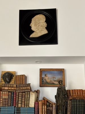 a picture of a statue of a man on a shelf in a room