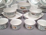 many different types of dishes and cups on the table