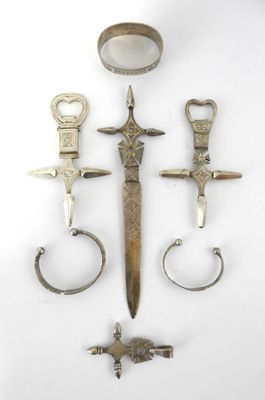 several different types of metal items are displayed on a white surface