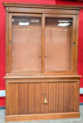 a wooden cabinet with a glass door on top of it