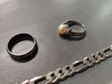 a ring and a chain on a table with a ring on it