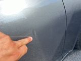 a hand that is touching the door handle of a car