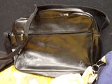 a black purse sitting on top of a yellow blanket