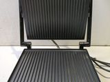 an image of a black and silver grill on a counter top