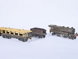 two toy trains sitting next to each other on a white surface