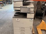 a printer that is sitting on a pallet in a warehouse