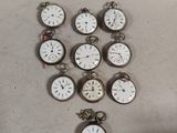 a lot of pocket watches sitting on a table