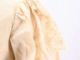 an image of a woman ' s blouse with a collar and lace on the shoulders