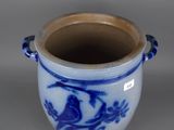 a blue and white vase with a bird design on it