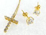 a close up of a necklace and earring with a cross on it