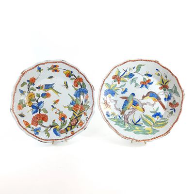 two plates with birds and flowers painted on them on a white surface